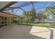Large screened patio offering outdoor living space with views of the landscaped backyard at 4978 Cedar Oak Way, Sarasota, FL 34233
