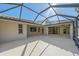 Spacious screened-in patio with tiled flooring and ample natural light, perfect for outdoor entertaining at 4978 Cedar Oak Way, Sarasota, FL 34233