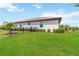 Spacious backyard with lush green grass, manicured hedges, and a black fence at 5165 Coral Reef Way, Bradenton, FL 34211