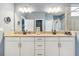 This bathroom features double sinks, granite countertops, modern fixtures and ample lighting at 5165 Coral Reef Way, Bradenton, FL 34211