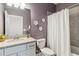 Cozy bathroom with decorative flowers, a modern toilet, and a white shower curtain at 5165 Coral Reef Way, Bradenton, FL 34211