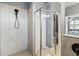 Modern bathroom featuring tiled shower with glass door and brushed black shower head at 5165 Coral Reef Way, Bradenton, FL 34211