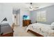 Bright bedroom with ceiling fan, dresser with tv, large window, and a workstation at 5165 Coral Reef Way, Bradenton, FL 34211