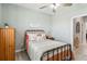 Cozy bedroom featuring a metal bed frame, soft pillows, and a wooden dresser at 5165 Coral Reef Way, Bradenton, FL 34211