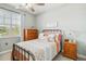 Cozy bedroom with a metal-framed bed, wooden dresser, bedside table, and neutral decor at 5165 Coral Reef Way, Bradenton, FL 34211
