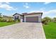 Attractive single-story home with a two car garage, lovely landscaping, and a brick paved driveway at 5165 Coral Reef Way, Bradenton, FL 34211