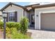 Inviting home exterior with neat landscaping and a cozy bench near the front door at 5165 Coral Reef Way, Bradenton, FL 34211