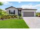 Charming one-story home with a well-manicured lawn, brick paved driveway, and two car garage at 5165 Coral Reef Way, Bradenton, FL 34211