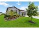 Landscaped front yard with a beautiful lawn and a charming one-story home at 5165 Coral Reef Way, Bradenton, FL 34211