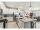 Kitchen features stainless appliances, granite counters, subway tile backsplash, and central island at 5165 Coral Reef Way, Bradenton, FL 34211