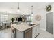 Open kitchen area with an island, stainless steel dishwasher, and seamless flow to living and dining at 5165 Coral Reef Way, Bradenton, FL 34211
