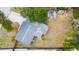 Birds-eye view of the home's roof and large backyard with mature trees and grass at 5307 47Th Street E Ct, Bradenton, FL 34203