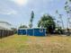 Well kept backyard with blue siding home and wooden fence at 5307 47Th Street E Ct, Bradenton, FL 34203