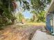 Large backyard with a storage shed, concrete slab, and mature trees at 5307 47Th Street E Ct, Bradenton, FL 34203