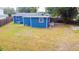 Home exterior showing the backyard with a nice lawn and small patio and fenced in yard at 5307 47Th Street E Ct, Bradenton, FL 34203