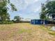 Grassy backyard featuring a blue home with white trim and a wooden fence at 5307 47Th Street E Ct, Bradenton, FL 34203