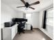 Spacious bedroom with a desk, multiple monitors, and natural light at 5307 47Th Street E Ct, Bradenton, FL 34203