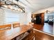 Dining room with a large wooden table and views of the kitchen and living room at 5307 47Th Street E Ct, Bradenton, FL 34203