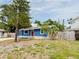 Charming blue home featuring a bright red door, stone accents, and well-manicured landscaping at 5307 47Th Street E Ct, Bradenton, FL 34203