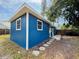 Cozy home featuring blue siding, white trim, stepping stones, and fenced yard at 5307 47Th Street E Ct, Bradenton, FL 34203