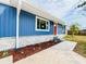 The exterior of this charming blue home features a well-manicured lawn and attractive landscaping at 5307 47Th Street E Ct, Bradenton, FL 34203