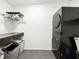 Efficient laundry room with a stacked washer/dryer and storage at 5307 47Th Street E Ct, Bradenton, FL 34203