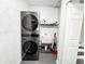 Convenient laundry room with a stacked washer/dryer and utility sink at 5307 47Th Street E Ct, Bradenton, FL 34203