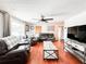 Comfortable living room offers hardwood floors, comfortable leather seating, and lots of natural light at 5307 47Th Street E Ct, Bradenton, FL 34203