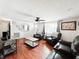 Well-lit living room featuring hardwood floors, comfortable leather seating, and lots of natural light at 5307 47Th Street E Ct, Bradenton, FL 34203