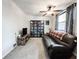 Cozy living room with a leather couch, bookshelf and a TV at 5307 47Th Street E Ct, Bradenton, FL 34203