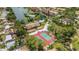 An aerial view shows the community pool, tennis courts, and lake at 5632 Ashton Lake Dr # 5632, Sarasota, FL 34231