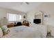 Bedroom featuring a bed, desk, ceiling fan, and a window with natural light at 5632 Ashton Lake Dr # 5632, Sarasota, FL 34231