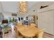 Elegant dining room featuring a unique light fixture, a spacious table, and comfortable seating at 5632 Ashton Lake Dr # 5632, Sarasota, FL 34231
