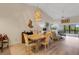 Open dining room with stylish lighting and a view to the outdoors at 5632 Ashton Lake Dr # 5632, Sarasota, FL 34231