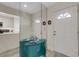 Hallway featuring a mirrored console, with views of the front door and kitchen, creating an open feel at 5632 Ashton Lake Dr # 5632, Sarasota, FL 34231