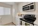 Modern kitchen featuring stainless steel appliances, white cabinetry, and ample counter space for cooking at 5632 Ashton Lake Dr # 5632, Sarasota, FL 34231