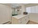 Bright kitchen with white cabinets, quartz countertops, and a view of the entryway and storage at 5632 Ashton Lake Dr # 5632, Sarasota, FL 34231