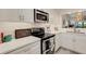 Contemporary kitchen featuring stainless steel appliances, white cabinets and countertops, and subway tile backsplash at 5632 Ashton Lake Dr # 5632, Sarasota, FL 34231