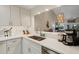 Beautiful kitchen featuring white cabinets, quartz countertops, and stainless steel appliances with open view at 5632 Ashton Lake Dr # 5632, Sarasota, FL 34231