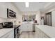 Bright kitchen boasts white cabinets, stainless steel appliances, and a stylish island for ample workspace at 5632 Ashton Lake Dr # 5632, Sarasota, FL 34231