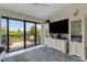 Living room boasting a large television, custom built-ins, and access to an outdoor deck at 5632 Ashton Lake Dr # 5632, Sarasota, FL 34231