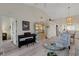 Open-concept living space with a piano, display cabinet, and seamless access to the dining area at 5632 Ashton Lake Dr # 5632, Sarasota, FL 34231