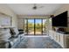 Cozy living room with a comfortable seating area, a large window, and access to a private deck at 5632 Ashton Lake Dr # 5632, Sarasota, FL 34231