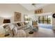 Inviting living room with comfortable seating and access to a private deck with a lush view at 5632 Ashton Lake Dr # 5632, Sarasota, FL 34231