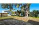 A large tree graces the backyard with a patio and white storage shed at 5706 10Th Avenue Dr W, Bradenton, FL 34209