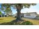A generous yard featuring a mature tree, shed, screen room, and patio area, ideal for entertaining at 5706 10Th Avenue Dr W, Bradenton, FL 34209