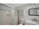 All-white bathroom featuring a shower, a white vanity with a marble countertop, and decorative lighting at 5706 10Th Avenue Dr W, Bradenton, FL 34209