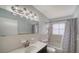 Well-lit bathroom with a large vanity, combination tub and shower and modern fixtures at 5706 10Th Avenue Dr W, Bradenton, FL 34209