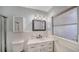 Updated bathroom featuring a marble vanity, light fixtures, and a shower and tub at 5706 10Th Avenue Dr W, Bradenton, FL 34209
