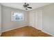 Neutral bedroom featuring a ceiling fan, hardwood floors, and a double closet at 5706 10Th Avenue Dr W, Bradenton, FL 34209